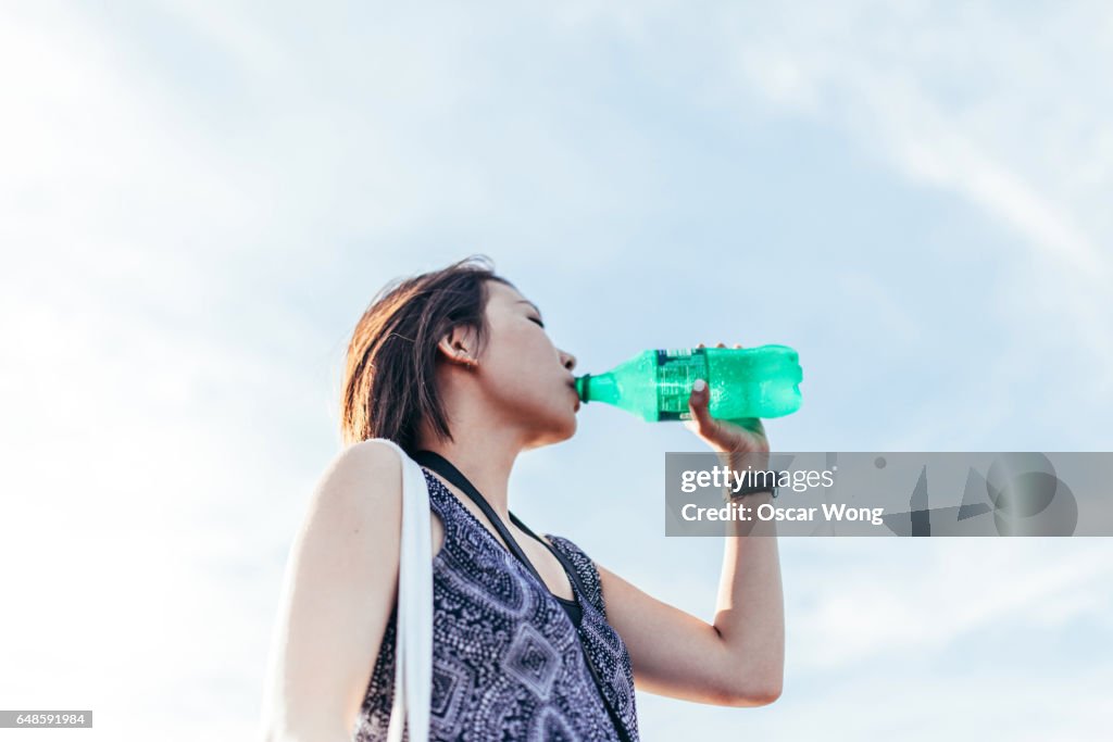 Young woman drinking bootle water