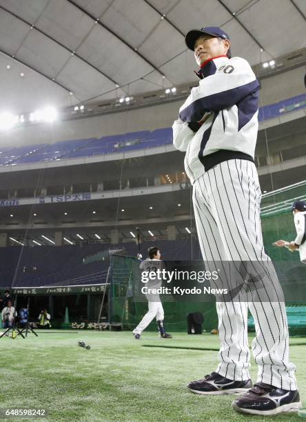 Japan manager Hiroki Kokubo presides over a training session at Tokyo Dome on March 6 of his squad for the World Baseball Classic. After the...