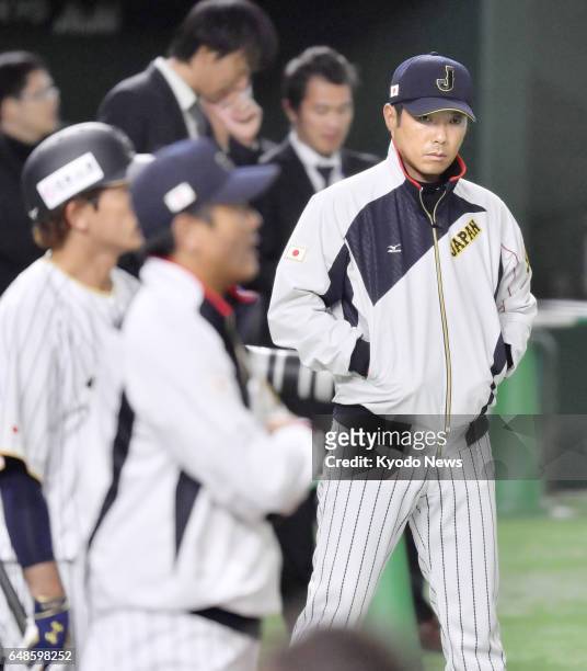 Japan manager Hiroki Kokubo presides over a training session at Tokyo Dome on March 6 of his squad for the World Baseball Classic. After the...