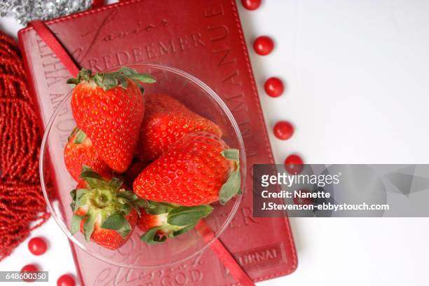 closeup of strawberries on a journal - nanette j stevenson stock pictures, royalty-free photos & images
