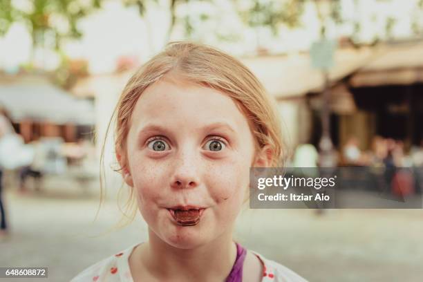 girl eating candy - chocolate eating ストックフォトと画像