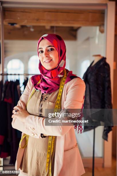 Portrait of fashion designer muslim woman in her work space.