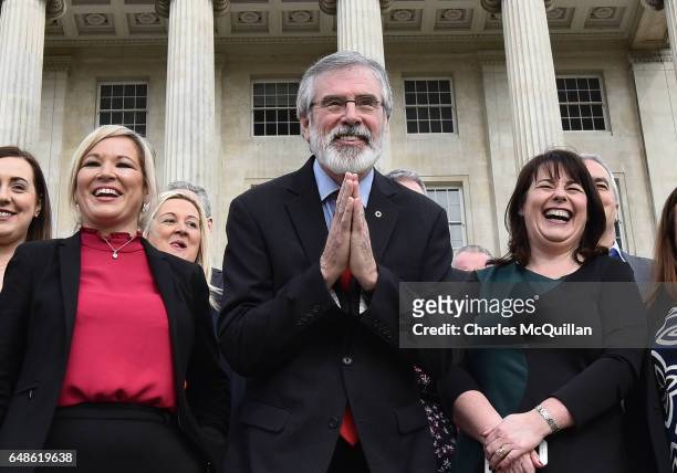 Sinn Fein president Gerry Adams bows to a group of Japenese tourists as he attends a press call alongside northern leader Michelle O'Neill and...
