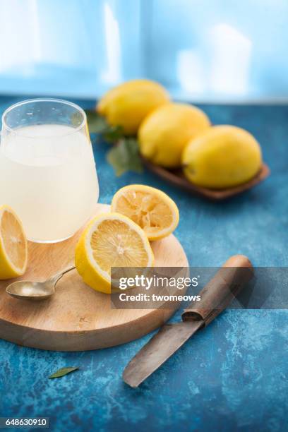 lemons and juice in glass. - lemon juice stock pictures, royalty-free photos & images