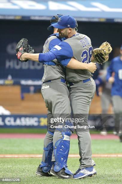 Pitcher Josh Zeid and catcher Ryan Lavarnway of Israel celebrate after winning the World Baseball Classic Pool A Game One between Israel and South...