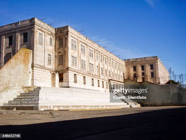 looking at cell block from alcatraz rec yard - prison cell block stock pictures, royalty-free photos & images
