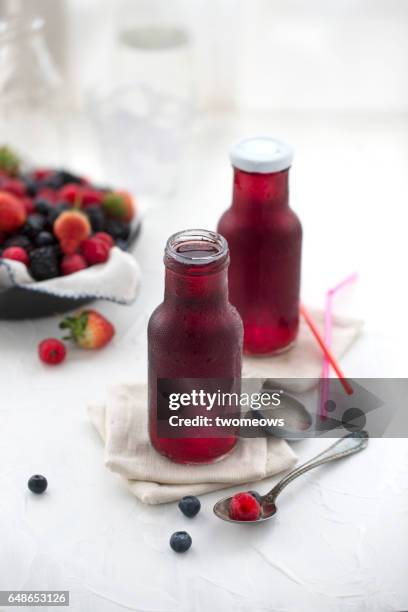 mix berry fruit juice in bottles. - antioxidant stock pictures, royalty-free photos & images