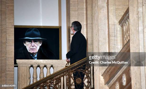 Sinn Fein president Gerry Adams pauses for a moment as he looks at a portrait of the late Ian Paisley before a press call at Stormont on March 6,...