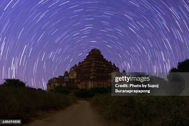 dhammayan gyi temple in  bagan under star trail with long exposure , bagan , myanmar - bagan temples damaged in myanmar earthquake stock pictures, royalty-free photos & images