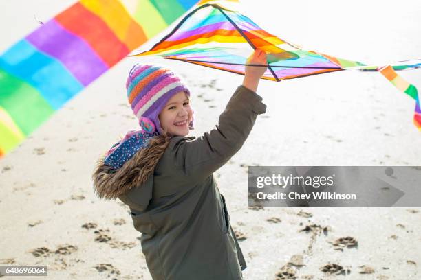 young girl running with kite on a beach - waterford stock pictures, royalty-free photos & images