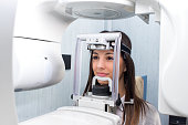 Girl taking digital 3D panoramic dental x-ray.