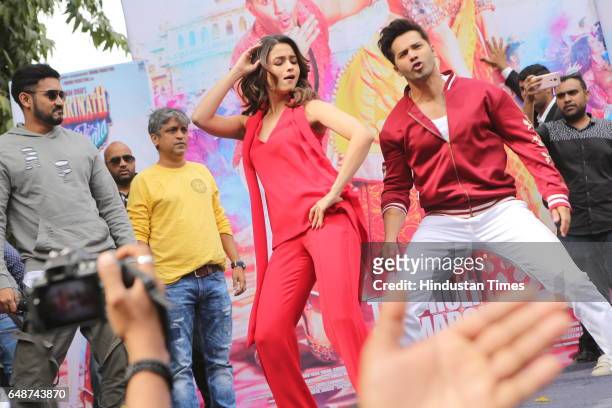 Bollywood actors Varun Dhawan and Alia Bhatt dance during promotion of their upcoming movie Badrinath Ki Dulhania at Hindu college of Delhi...
