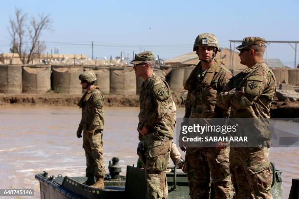 Army forces supervise during a training session at the Taji camp, north of Baghdad, with Iraqi soldiers, aimed at preparing them to install floating...