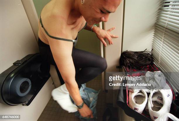 Angel puts on women's clothing while dressing in a public bathroom at the Gay Man's Health Crisis Center in the meatpacking district of New York City...