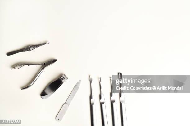 manicure pedicure tools top view with white copy space for banner designing - nail scissors - fotografias e filmes do acervo