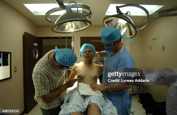 Colombian Resident Doctor Carlos Borritica draws lines on the chest of Maria Concepcion Lopez while Mexican resident doctor Enrique Sanchez helps...