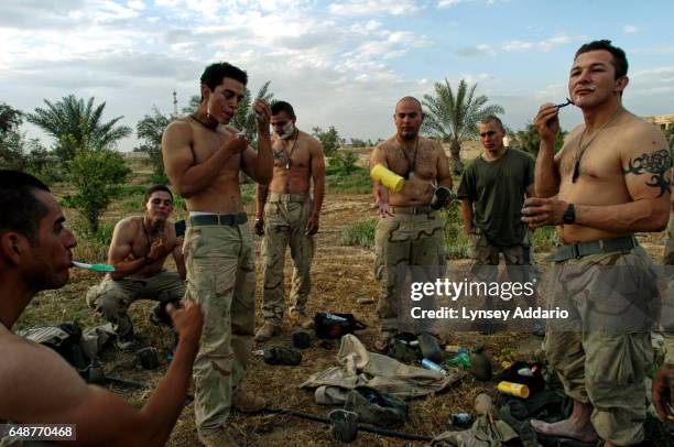 United States Marines take a break to shave in front of one of Saddam Hussein's presidential palaces the day Tikrit fell from Republican Guard rule...