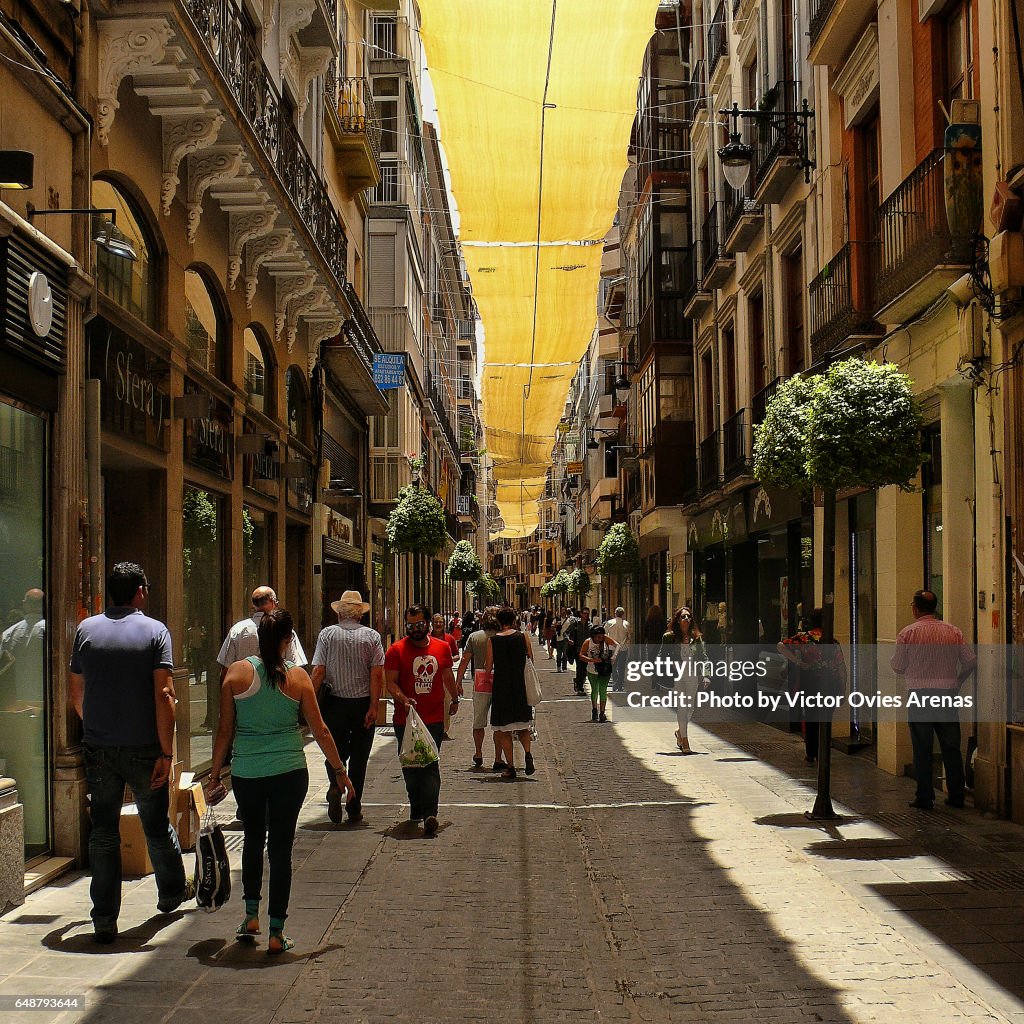 Sunshade along Mesones shopping street in mid summer in Granada, Andalusia, Spain