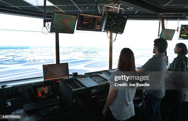 Air traffic controllers keep watch using Data Comm, part of the FAA's Next Generation Air Transportation system in the control tower at Miami...