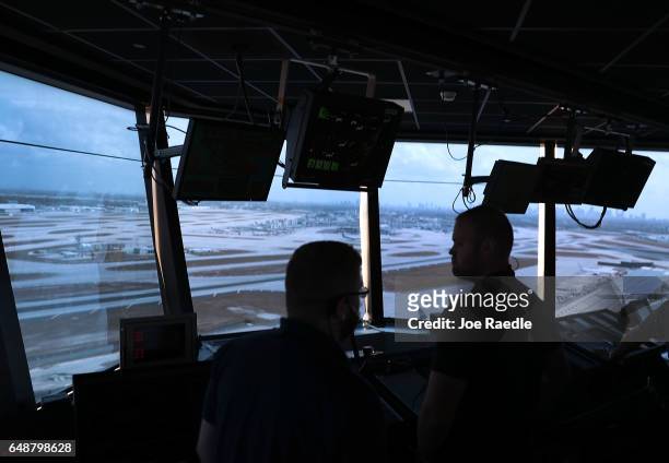 Air traffic controllers keep watch using Data Comm, part of the FAA's Next Generation Air Transportation system in the control tower at Miami...