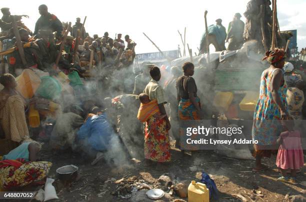 Soldiers with the Congolese army await gasoline at the stadium, where many had spent the night in their trucks while en route to their deployment in...