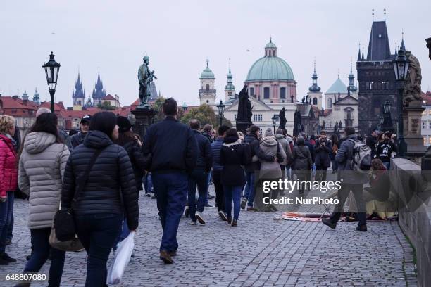 Tourists walking in the street of Prague, the capital city of Czech Republic during the winter on a cloudy day. Most of the shots are in the...