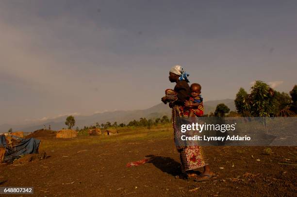 Pygmy family walks among the fields of a village outside of Goma, North Kivu province, Democratic Republic of the Congo on June 18, 2006. Although...