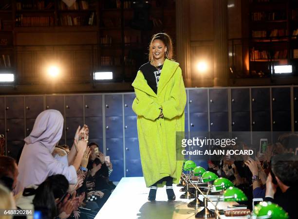 Barbadian singer Rihanna is applauded by English fashion model Cara Delevingne during Rihanna's Fenty Collection from PUMA women's Fall-Winter...