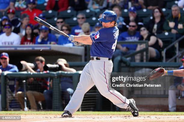 Travis Snider of the Texas Rangers bats against the Kansas City Royals during the spring training game at Surprise Stadium on February 26, 2017 in...