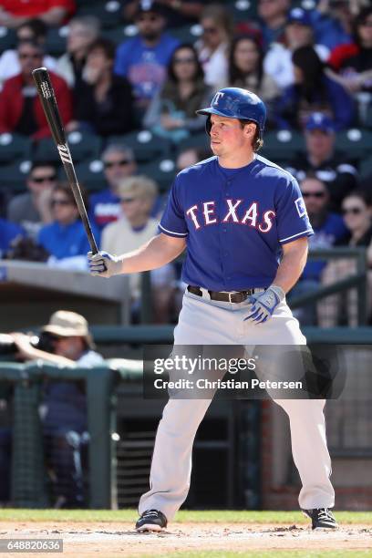 Travis Snider of the Texas Rangers bats against the Kansas City Royals during the spring training game at Surprise Stadium on February 26, 2017 in...