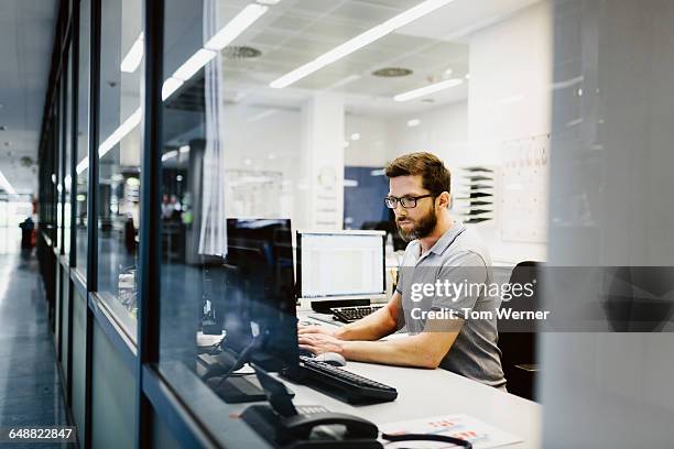 engineer in control room of a factory - topnews foto e immagini stock