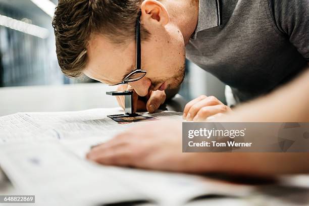 quality control by an engineer in a printery - tipografia foto e immagini stock