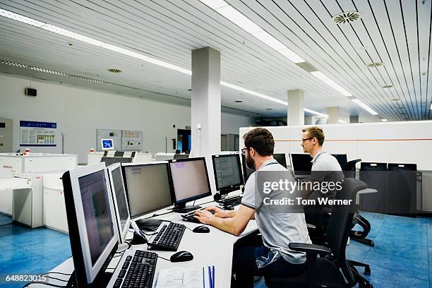 engineers in a modern and clean control room - control centre stock pictures, royalty-free photos & images