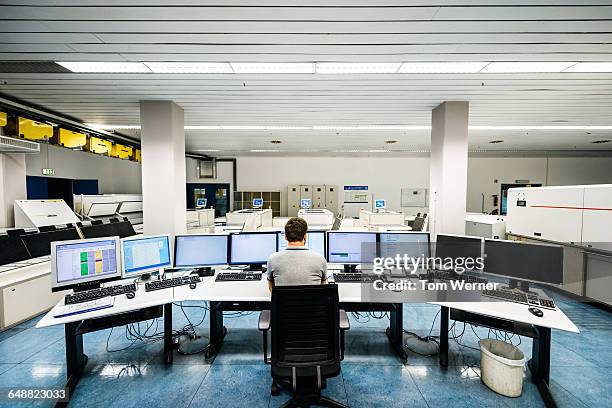 engineer in a modern and clean control room - control room monitors stockfoto's en -beelden