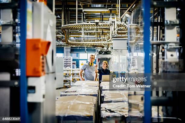 engineers working on laptop in a large printer - paper industry stock-fotos und bilder