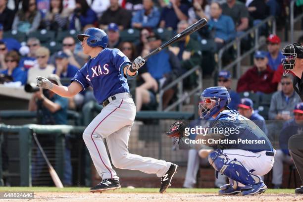 Doug Bernier of the Texas Rangers bats against the Kansas City Royals during the spring training game at Surprise Stadium on February 26, 2017 in...