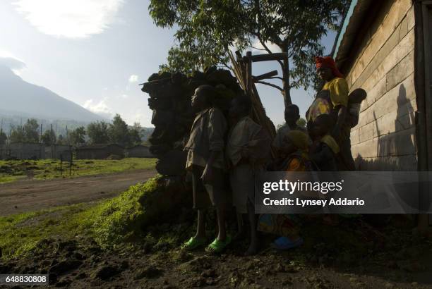 Villagers hide behind walls near a church as Laurent Nkunda's National Congress for the Defence of the People, CNDP, forces fire towards Congolese...