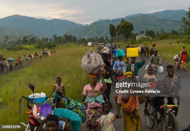 Thousands of Congolese people flee the village of Sake towards Goma as intense fighting takes place between the Congolese Army, the FDRC, and...