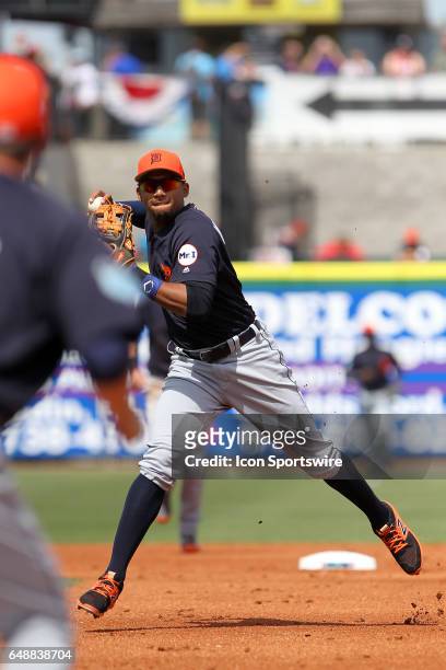 Dixon Machado of the Tigers sets up to throw the ball to first base for the out during the spring training game between the Detroit Tigers and the...