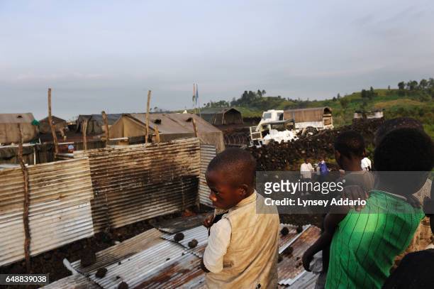 Congolese children, displaced from the villages of Rugari, Kiwanga, and those around Rutshuru, watch the United Nations Organization Stabilization...