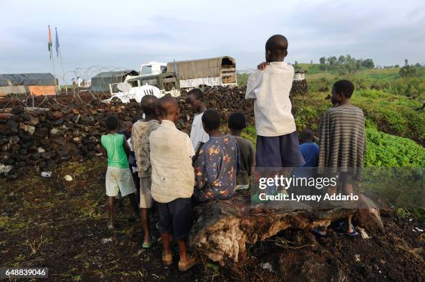 Congolese children, displaced from the villages of Rugari, Kiwanga, and those around Rutshuru, watch the United Nations Organization Stabilization...