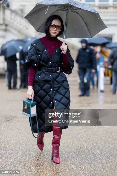 Yoyo Cao wearing a black puffy coat, turtleneck, overknees outside Stella McCartney on March 6, 2017 in Paris, France.