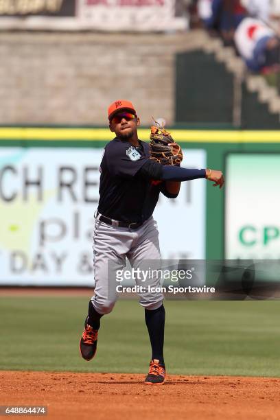 Dixon Machado of the Tigers throws the ball over to first base during the spring training game between the Detroit Tigers and the Philadelphia...