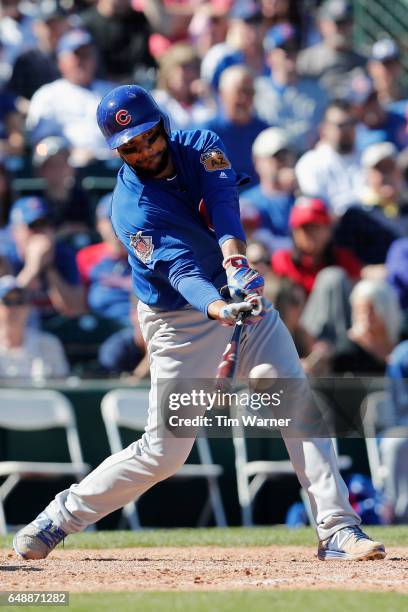 Carlos Corporan of the Chicago Cubs hits an RBI single in the fourth inning against the Los Angeles Angels during the spring training game at Tempe...