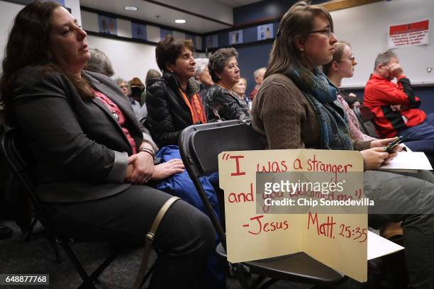 People in an overflow room listen to testimony during a hearing on a propsal to become a 'sanctuary city' at City Hall March 6, 2017 in Rockville,...