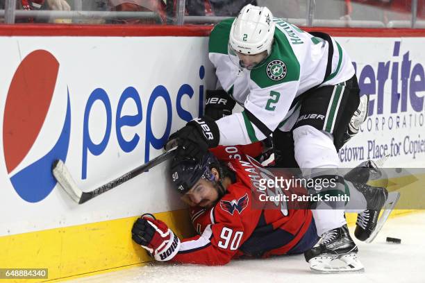 Marcus Johansson of the Washington Capitals is checked by Dan Hamhuis of the Dallas Stars during the second period at Verizon Center on March 6, 2017...