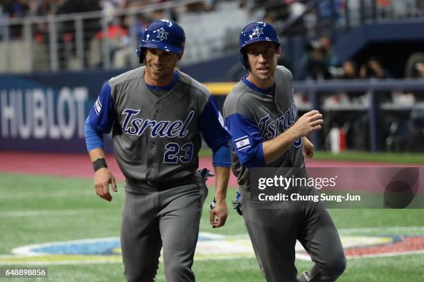 Outfielder Sam Fuld and Infielder Ty Kelly of Israel celebrate after scoring runs in the top of the first inning during the World Baseball Classic...