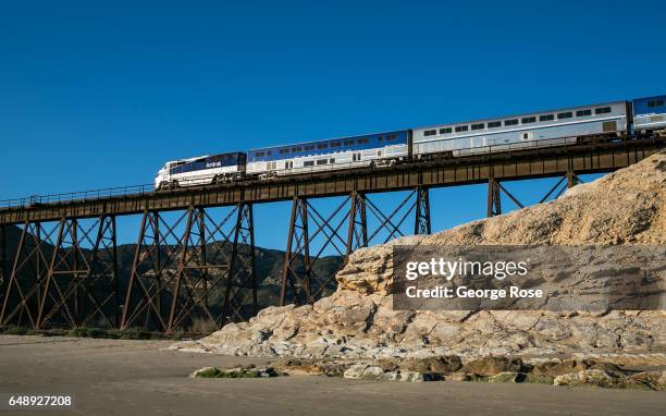 An Amtrak Surfliner train passes over the steel trestle at Gaviota Beach on December 28 in Gaviota State Park, California. Because of its close...