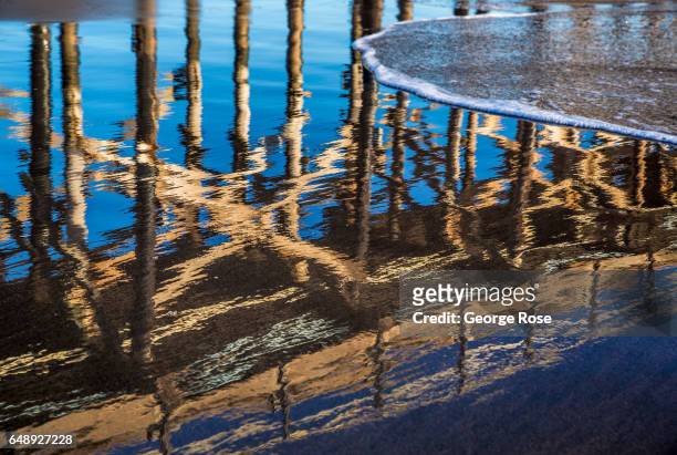 The abandoned pier at Gaviota Beach is reflected in the sand on December 28 in Gaviota State Park, California. Because of its close proximity to the...