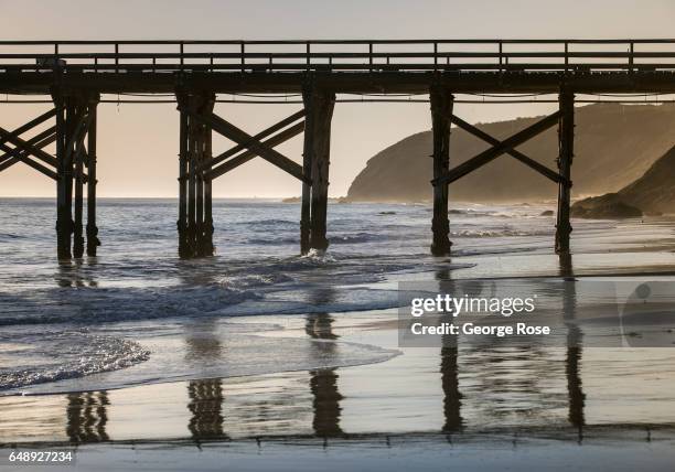 The abandoned pier is silhouetted against a setting sun on December 28 in Gaviota State Park, California. Because of its close proximity to the...